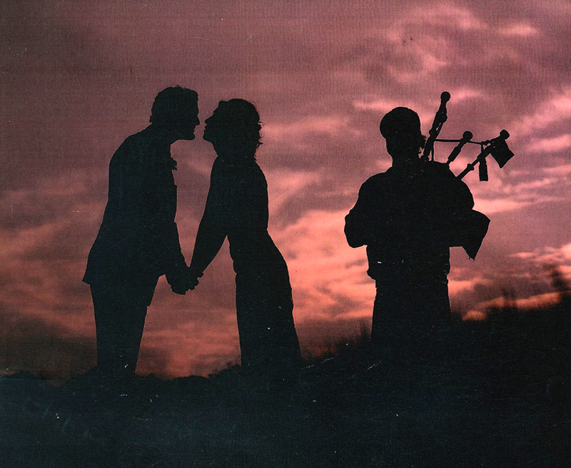 Kevin Regan playing bagpipes at dusk
